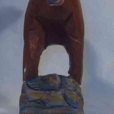 Galloping Horse front: The wooden sculpture depicts a brown horse standing on a painted rock.