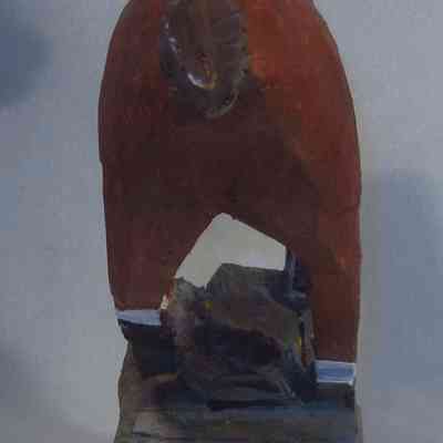 Galloping Horse rear: A wooden horse sculpture is viewed from the rear on a painted base.