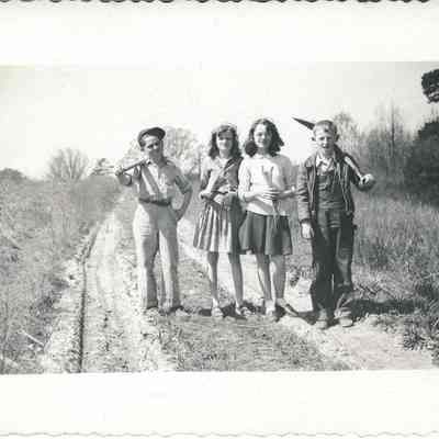 Students Standing on Dirt Road