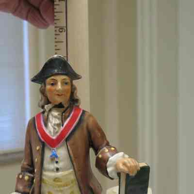 Figurine: Painted ceramic figurine of Benj. Franklin wearing a Masonic apron and Master's Jewel. Damage to neck area, once repaired.