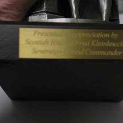 Figurine: Pewter figurine of George Washington standing by Master's pedestal with gavel, apron, Past Master's Jewel holding a hat in front of a chair with coat draped over it. Plaque on front reads"Presented in appreciation by Scottish Rite, SJ Fred Kleinknecht, Sovereign Grand Commander". On opposite side, plaque reads "The George Washington Masonic National Memorial 200th Anniversary Commemorative Sculpture 'Worshipful George Washington' by Lawrence J. Nowlan". Strike No. 312/5000, 1998 AMA