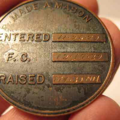 Coin: Copper pocket coin. On one side emblems of Masonry. On the other side the dates that Evan David Jones Jr. was made a Mason (engraved): Entered 11/25/29, F.C. 12/17/29, Raided 1/14/30 M.M. We also have his apron CN 2094. 1 1/4" diam.