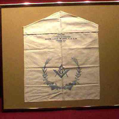 Apron: White cotton, blue printing. 13 1/2" x 13" with Square & Compasses on body and All Seeing Eye on flap. Souvenir of Centennial Celebration, Grand Lodge of Ohio, October 21, 1908