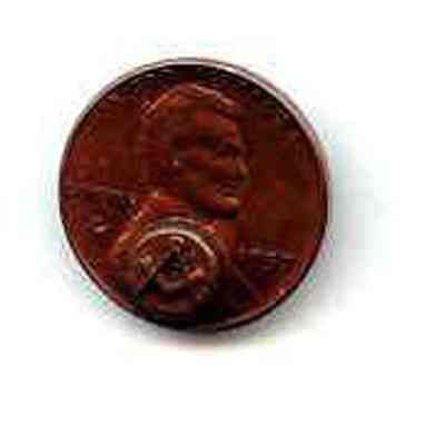 Metal coin - U. S. one cent coin with the square and compass stamped below Lincoln's hear. Dated 1957
