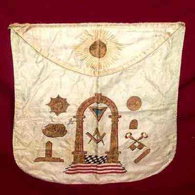 Apron: Blue green apron with Masonic emblems painted in gold, sun on flap. Belonged to Robert McMannus, United Lodge, Brunswick, Maine. Dated November, 1823