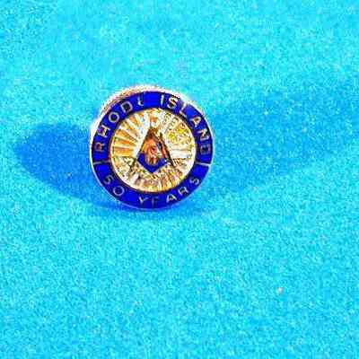 Pin, Fraternal: Lapel pin for 50 years service from Rhode Island. 7/16" diam. Blue edge with Square & Compasses in center
