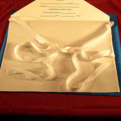 Apron: Sample of the apron presented to each candidate for the One Day Class in Masonry, April 27, 2002. White apron wwith One Day Class printing on inside flap