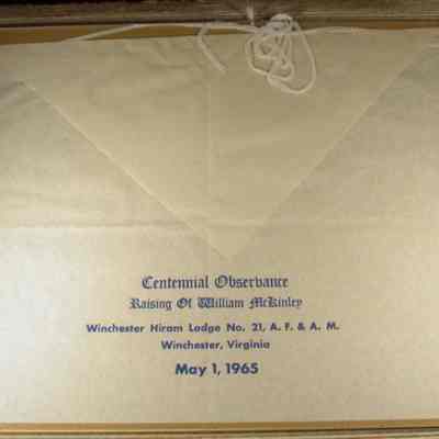 Apron-Centennial observance raising of William McKinley, Winchester Hiram Lodge #21 A. F. & A. M., Winchester, Virginia, May 1, 1965. Paper apron - 15" x 12 Apron - Centennial observance raising of William McKinley, Winchester Hiram Lodge #21 A.F.&A.M. Winchester, Virgina, May 1, 1965. Paper apron-15"x12" with blue lettering