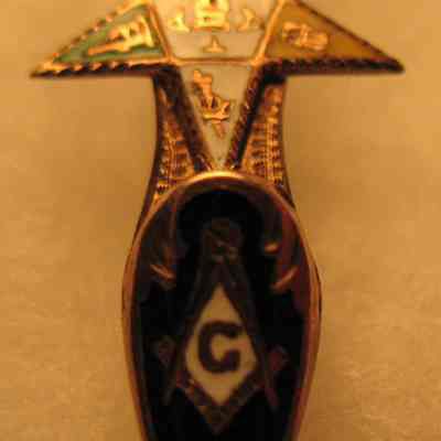 Pin, Fraternal: Slipper lapel pin, 3/4" long. It has the Eastern Star symbol and a Square and Compass on it.