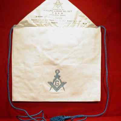 Apron: White leather with pink and blue stitching belonging to Myron Seifert