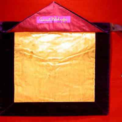 Apron: White felt with purple edging, violet backing. 13 1/2" x 16" with All Seeing Eye on Flap. Name "Earnest F. Schaefer" stitched in gold under flap