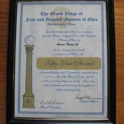 Certificate: Framed Fifty Year certificate, presented to Aaron Hard Jr. by the Grand Lodge of Ohio. Certificate is in a black plastic frame, 12" x 9/12"