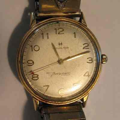 Wristwatch: Gold Hamilton wristwatch. Round face. Wrist band has Square & Compass on it. Inscritpion on the back reads as follows: "Russell O. Hotchkiss W.P. 1958-1962 Ida McKinley Chapter O.E.S. Niles O.