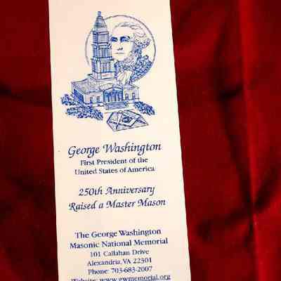 Bookmark: Celebrating the 250th Anniversary of the raising of George Washington,a Master Mason. White paper with blue lettering.