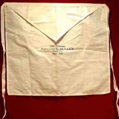 Apron: 100th Anniversary of Flushing Lodge #298 F. & A. M., Flushing Ohio, dated 1857-1957. Blue lettering "100 Anniversary"