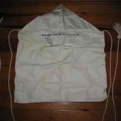Apron: Presented by Willoughby Lodge No. 302. White leather candidates apron. Lined with cotton cord and tassels. 14" x 12" with above printed inscription under flap.