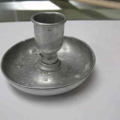 Candleholder: Circular tin single candle holder, no handle. Mfg. by The Pettibone Bros Mfg. Col, Cin ti.O.