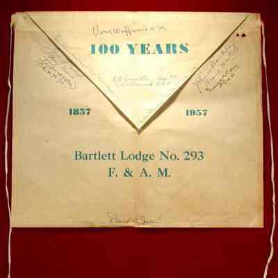 Apron - 100 years, Bartlett Lodge #293 F&AM. 13"x15" white paper apron, blue green lettering, several signatures (13), 5 on flap, 8 on body