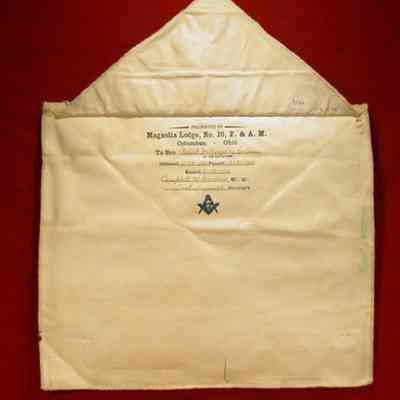 Apron: White lambskin. 12 1/2" x 14 1/2". Presented by Magnolia Lodge #20 F. & A. M., Columbus, Ohio to Bro. Robert Willoughby Collns, IN 2/24/1915, PA 3/31/1915 RA 5/13/1915