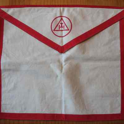 Apron: Chapter apron. White with red braid border and ties. Red Chapter symbol on flap. 13 1/2" x 15"