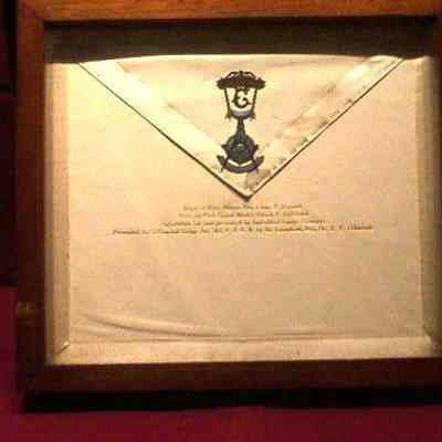 Apron: White lambskin apron and Past Master's Jewel in walnut case presented by Collinwood Lodge #582