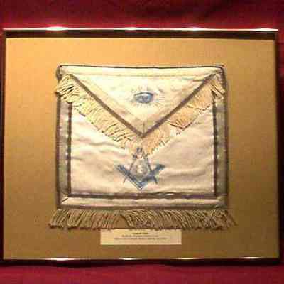 Apron: White leather apron, blue edging, white tassels. Printed in blue, All Seeing Eye, Sq. & Comp. & G - front, framed. Under flap "Presented by Toledo Lodge #144 F. & A. M., Toledo, Ohio to Bro. Joseph Addison Cleary, Init. February 22, 1927, Pass. March 7, 1927, Raised March 30, 1927"