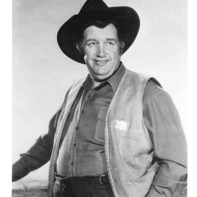 Andy Devine wearing sheriffs badge