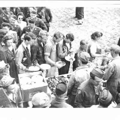 Military personnel and civilians at barbeque: Rodeo Dinner