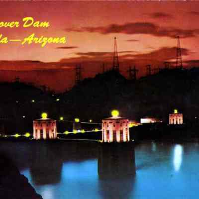 Night view of Hoover Dam with lake.