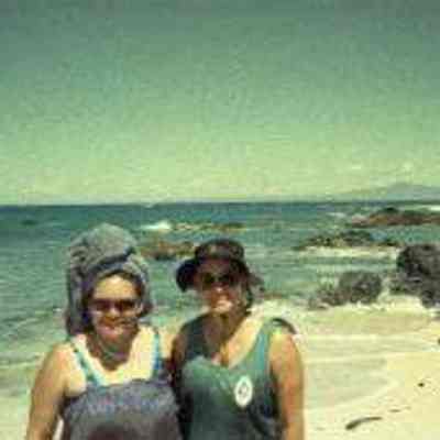 Two women on sandy white beach