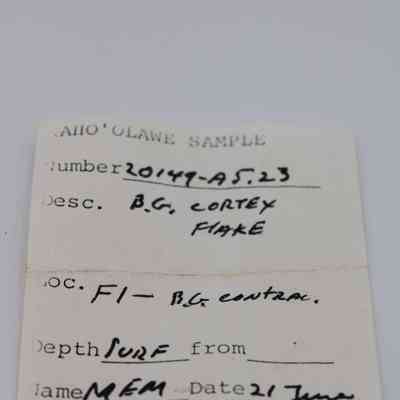Artifact slip for basaltic glass cortex flake: The artifact slip from Kaho'olawe denotes sample number 20149-A5.23, described as "B.G. cortex flake."