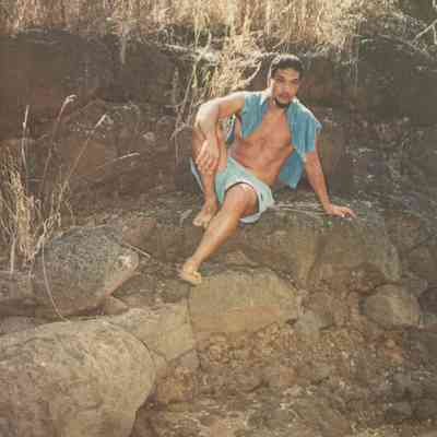 Man sitting on rock ledge