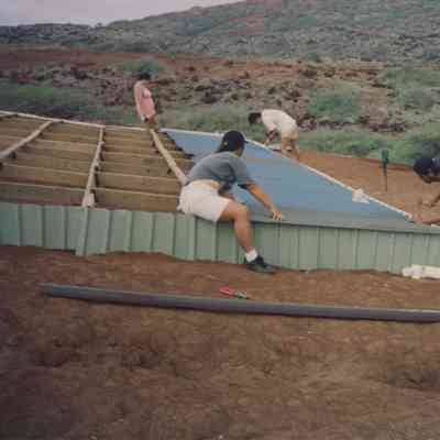Four people working on water catchment