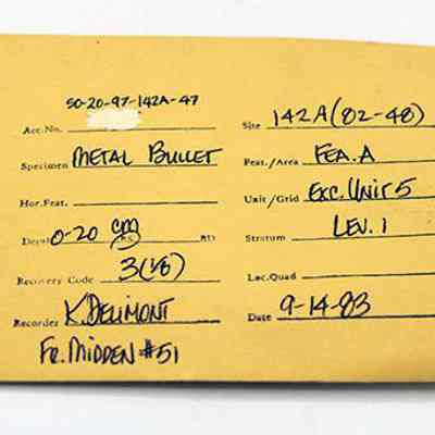 Artifact envelope for metal bullet: The image shows a labeled yellow artifact envelope detailing a "Metal Bullet" specimen, with various fields filled in including date, location, and recorder information.
