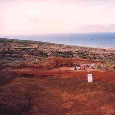 People and construction materials on hardpan terrain
