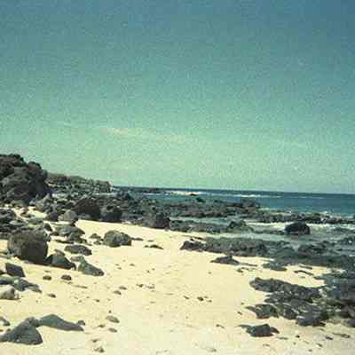 White sandy beach with rocks