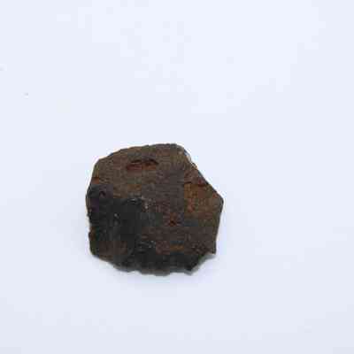 Closeup of glass flake: The image displays a single, dark brown glass flake with a rough texture, resting on a plain white background.