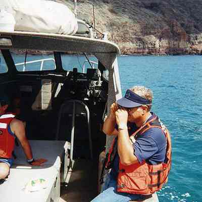Charles Lindsey taking photos on boat