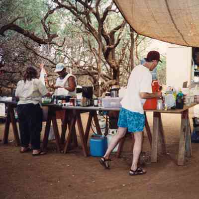 People working in the cooking area in camp
