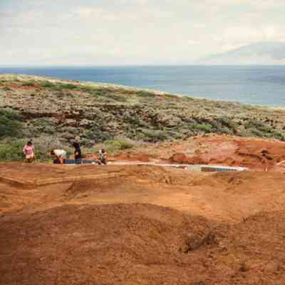People working near water catchment structure and water tank