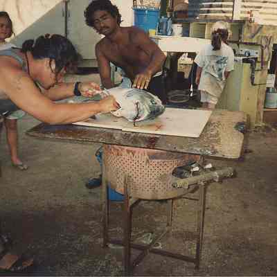 Two persons gutting fish