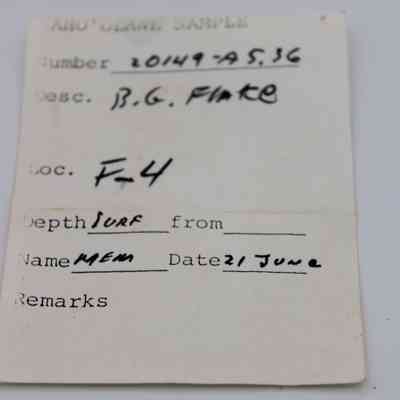 Artifact slip for basaltic glass flake: The image shows an artifact slip with details like number, description, location, depth, name, and date filled in, used for cataloguing archaeological samples.