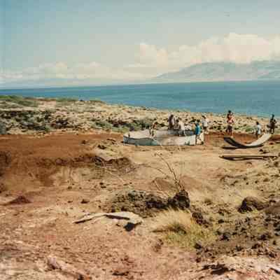 Group of people constructing a water catchment structure
