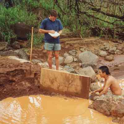 Men examining stream