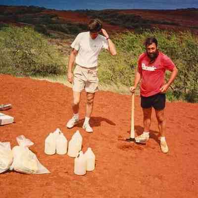 Two kāne (men) standing on hardpan terrain
