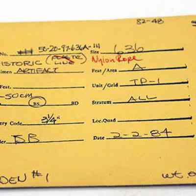 Artifact envelope for nylon rope: The image shows a yellow artifact record envelope with handwritten details including accession number, site, specimen type, depth, and date recorded.
