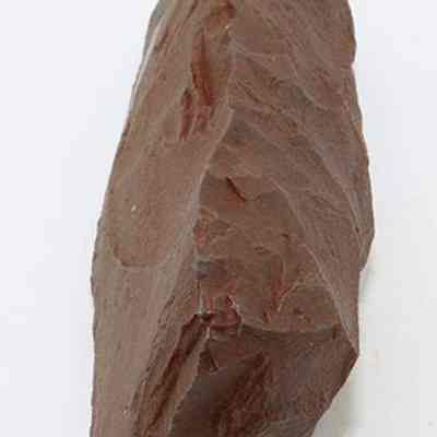 Lengthwise view of adze blank: The image shows a roughly hewn stone tool with sharp edges.