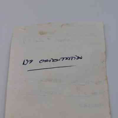 Back of artifact slip for glass core: The image shows the back of an artifact slip with handwritten text in blue ink and faint, printed details.