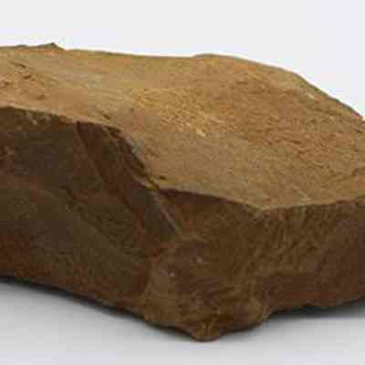 Profile of basalt drill: The image shows a profile of a brown stone drill with rough, jagged edges and a flat surface.