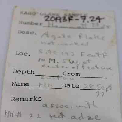 Artifact slip for an agate slip: The image shows an artifact slip detailing an agate flake, including location, depth, date, and remarks about its association with another object.
